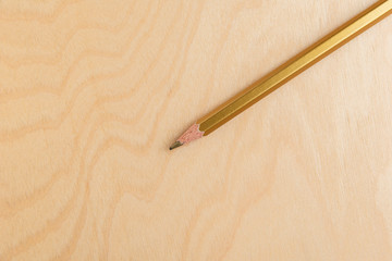 Gold Color Pencil Isolated On Wood Background