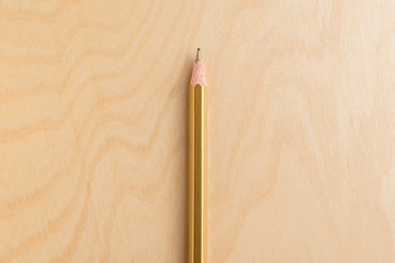 Gold Color Pencil Isolated On Wood Background