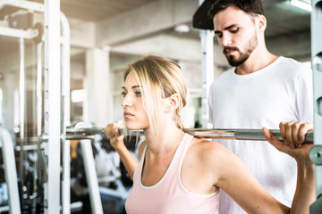 Couple of caucasian sport men women exercise partner in fitness gym