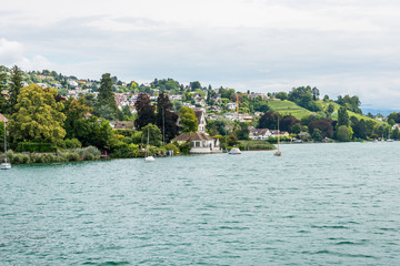 Fototapeta na wymiar Beautiful historic buildings on the lakeshore of Lake of Zurich, Switzerland.