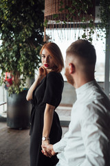 Fototapeta premium Beautiful woman in a black dress and a man in a white shirt.