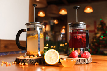 Many teapots with brewed fruit teas with different flavors. Natural fruit teas on the cafe table