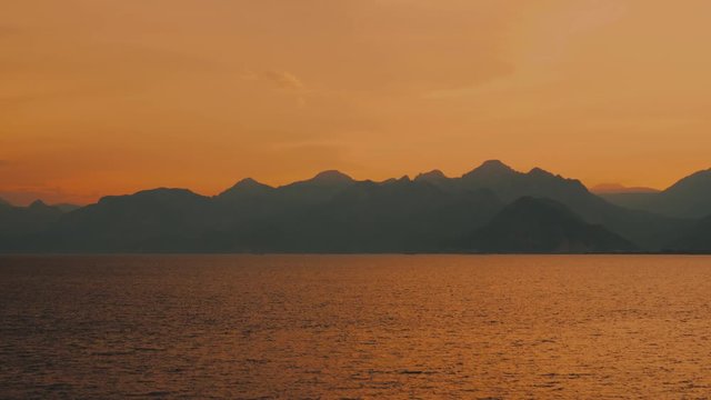 Great amazing panoramic landscape of sunset dramatic golden sky, dark sea water and orange horizon line. Turkey. Real time 4k video footage.