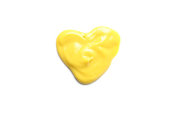 Fototapeta premium Heart made of yellow sauce isolated on white background