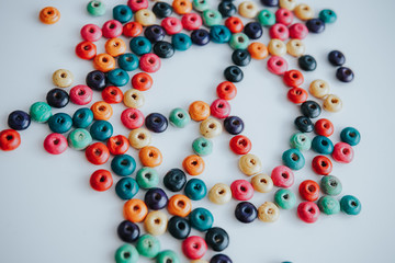 colorful beads with peace symbol on a white background