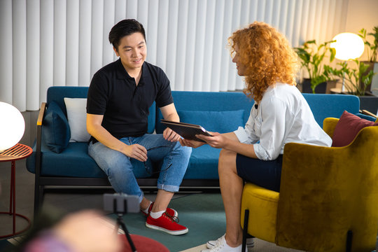 Smiling guy with woman on shooting indoors stock photo