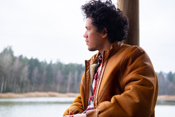 Latin American man looking relaxed at a lake 