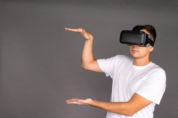 The guy in the glasses of virtual reality points to the field. Future and modern technologies.