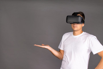 The guy in the glasses of virtual reality points to the field. Future and modern technologies.