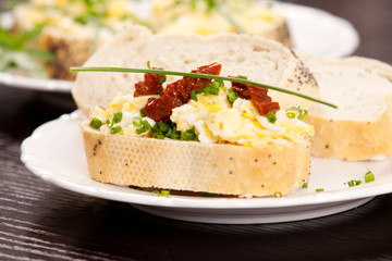Delicious fresh scrambled eggs and dried tomatoes sandwich