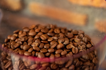 Selective focus roasted coffee beans in coffee beans blend machine bowl , roasted coffee beans
