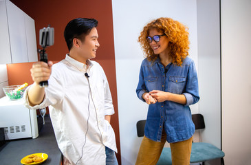 Smiling Asian man is interviewing pretty woman