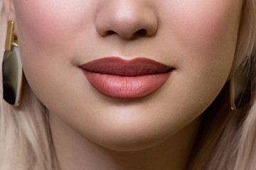 Sexual full lips. Natural gloss of lips and woman's skin. The mouth is closed. Increase in lips, cosmetology. Natural lips. Great summer mood with open eyes. fashion jewelry. Pink lip gloss