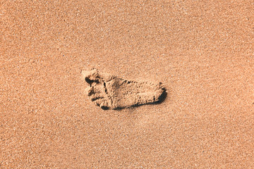 footsteps in the sand of a beach