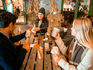 Happy pretty lady spending time with her friends in street cafe
