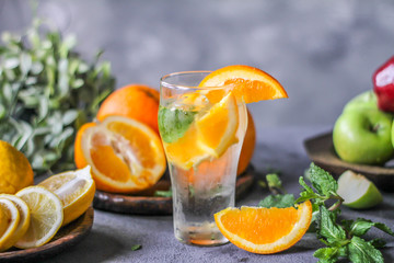 Photo of slice orange in a glass of water. Fresh orange on retro background. Orange Water. Sunkist. Summer drink. Fresh fruit. Image