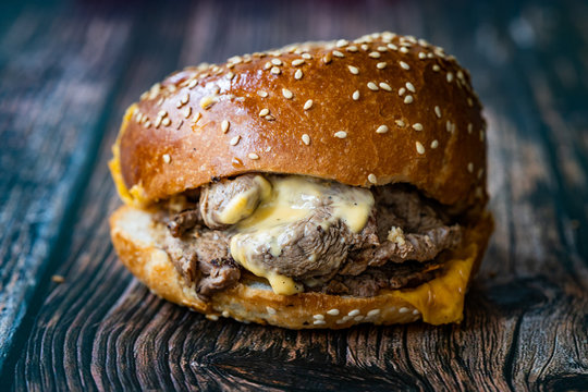 Steak Burger made with Lamb Meat Lokum and Cheddar Cheese / Hamburger or Cheeseburger on Wooden Surface.