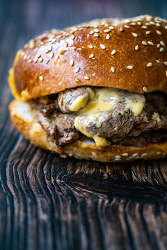 Steak Burger made with Lamb Meat Lokum and Cheddar Cheese / Hamburger or Cheeseburger on Wooden Surface.