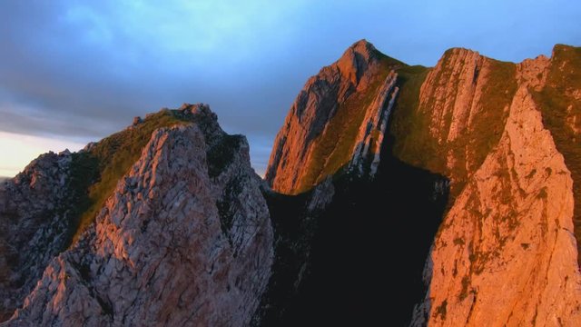 FPV aerial view panning over the Appenzell Alps, the Schaefler Ridge, at sunset, on a sunny summer evening, in Switzerland