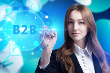 Business, Technology, Internet and network concept. Young businessman working on a virtual screen of the future and sees the inscription: B2B