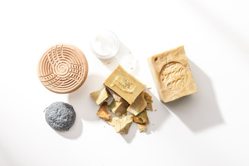 Aleppo soap with pumice and sponge on a white background seen from above