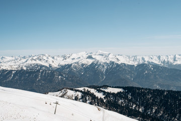 Fototapeta na wymiar Winter mountains, ski run. The view of the mountains and ski lift