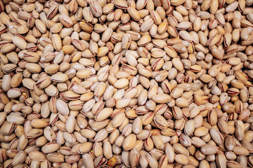 Background make from salt pistachios in a shell. A lot of pistachio nuts