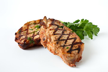 Grilled pork chops with vegetables-cherry tomatoes, peppers, parsley on a wooden Board. Isolate.
