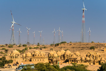 Fototapeta IINDIA, RAJASTHAN, JAISALMER, Chattris of Bada Bagh near Jaisalmer surrounded by wind generators obraz