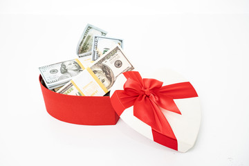 Dollars in a  gift box on a white background.  Valentine's Day. Birthday. Saving money.