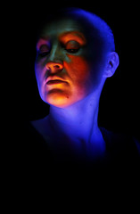 Artistic portrait of a lady created by multicolor light on a black background