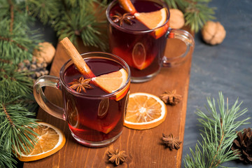 Christmas mulled wine with orange slices on the basis of red wine with spicy cinnamon sticks, star...