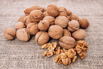 Mature walnuts on woven fabric. Nuts on linen fabric
