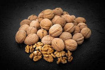 Walnuts on black background. Group walnuts on Healthy organic food concept.