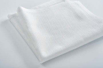White linen napkin on a white table