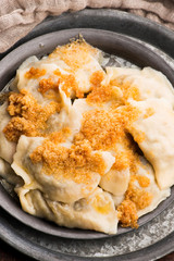 Boiled pierogi (Polish dumplings) stuffed with cabbage and mushrooms