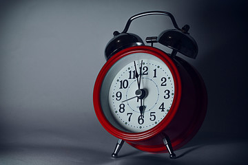 red alarm clock on dark background