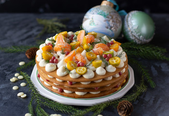 Layered cake with white ganache cream decorated with sliced kumquat, mandarin, cranberries.  Winter cake decoration, festive mood ..