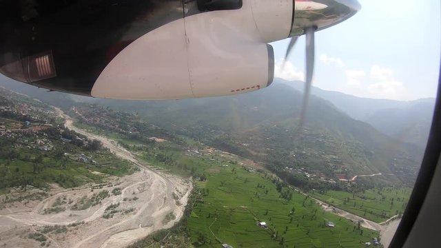 Air travel in Nepal, the engine with the propeller and the Tamakoshi River valley, tour from Ramechhap Airport to Lukla Airport. Jumping-off point for a climb up Mt. Everest Himalayas in Nepal