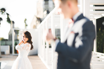 Perfect couple bride, groom posing and kissing in their wedding day