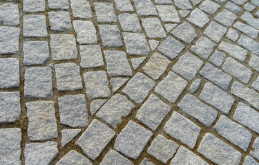 Old cobblestone pavement in the ancient European city