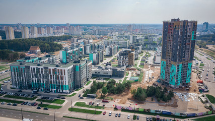 Aerial view residential neighborhoods and a new building. Construction of the Novaya Borovaya microdistrict in Minsk.