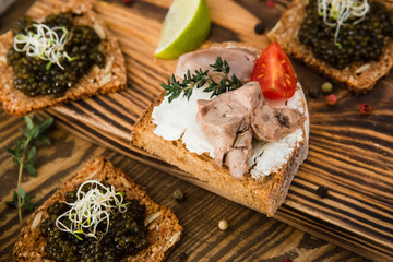 tasty snacks with cod liver with tomato