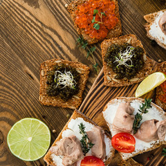 tasty snacks with cod liver with tomato