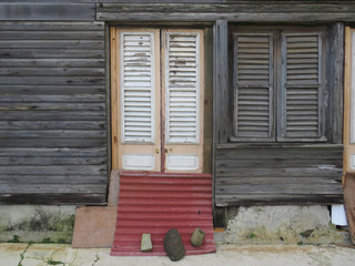 Fototapeta na wymiar Typical wooden facade in Martinique, French West Indies. Tropical wooden windows.