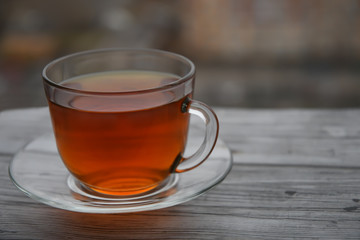 A cup of black tea on a wooden table