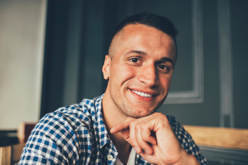 Naklejka premium Glad hipster relaxing in cafeteria
