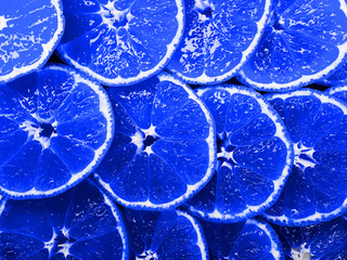 Blue tangerines bright and juicy sliced ​​lie on top of each other.