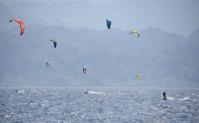 Kiters in Elat Israel enjoying the Red Sea with Jordanian Mountains on the background