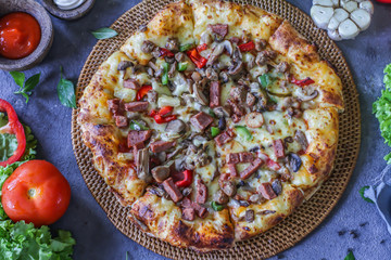 Photo of pizza on the table with ingredients around. Tasty pizza on the wooden background. Flat lay with top view. Italian pizza. Delicious pizza. Image